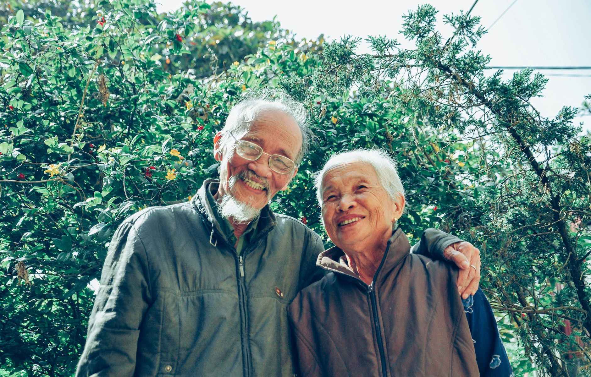 smiling man and woman wearing jackets