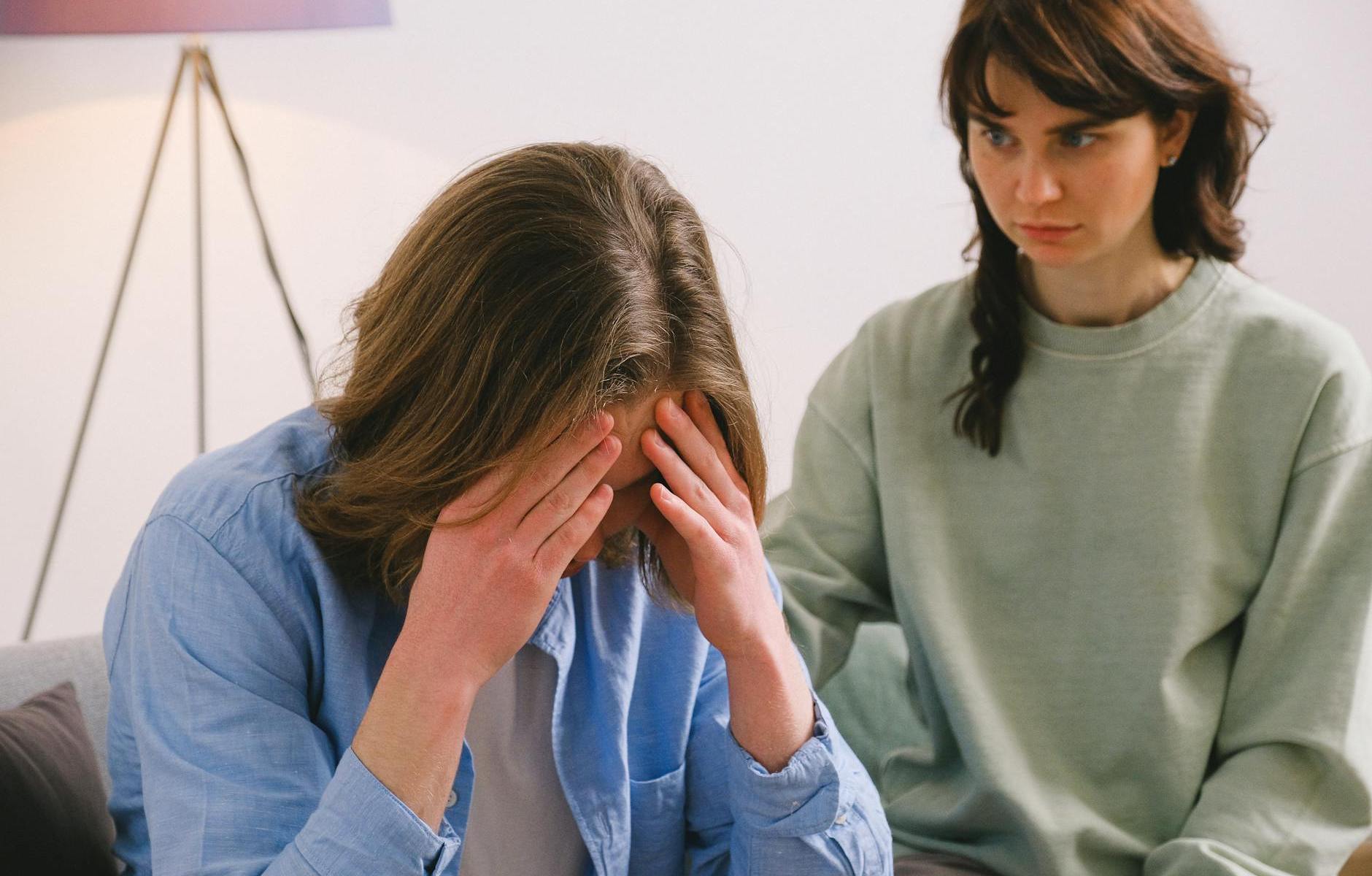 disappointed woman looking at sorrowful man