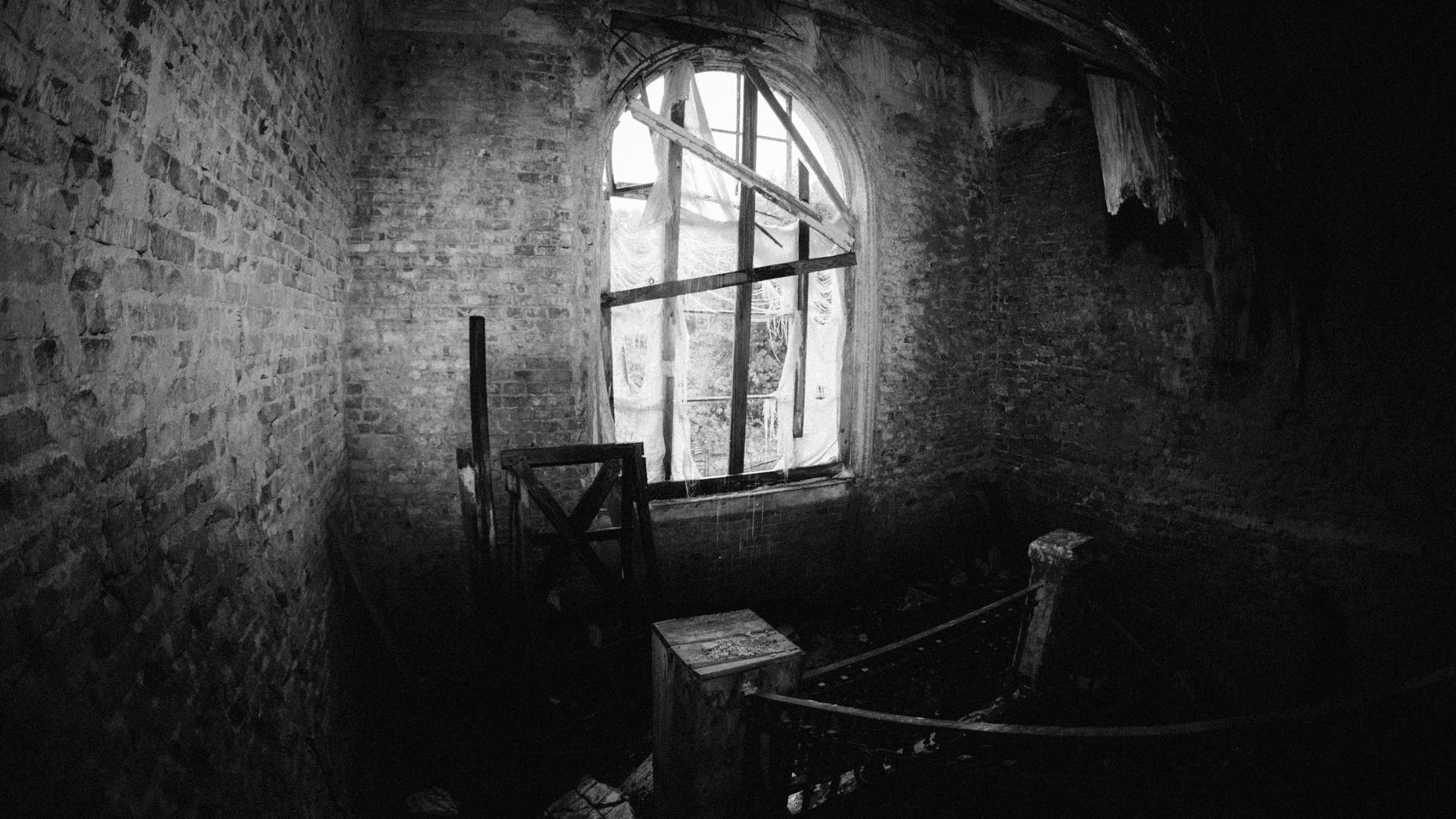 monochrome photo of interior of an abandoned house